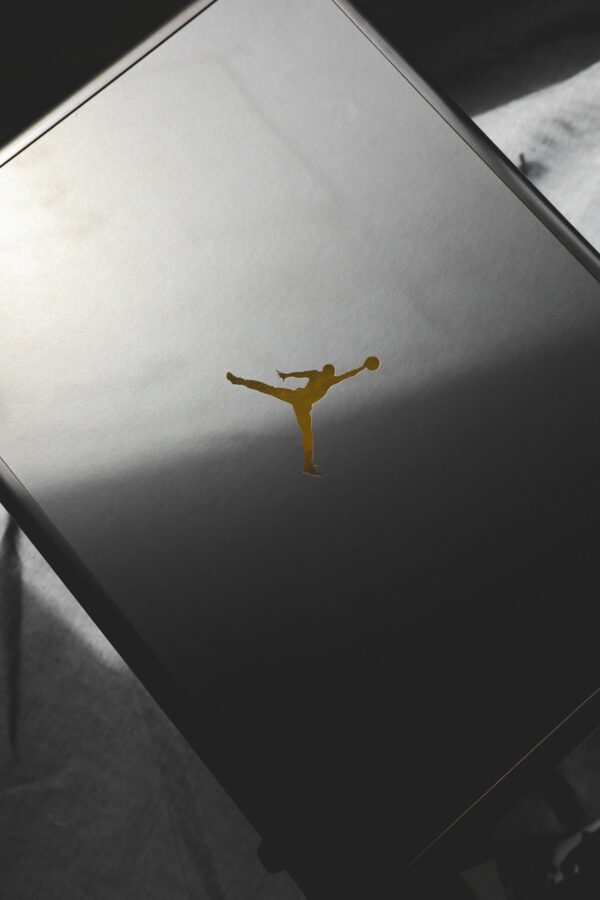 Minimalist black sneaker box featuring iconic basketball logo for impactful product display.