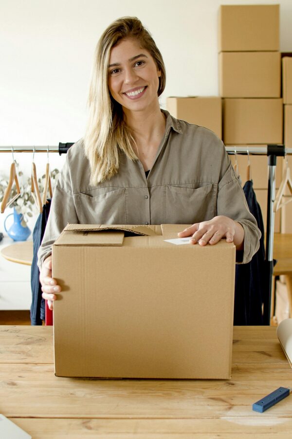 Woman managing online store packaging for small business indoors.
